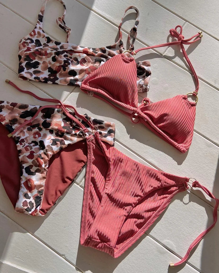 Two stylish women's bikinis on a white background; one features a pink and black leopard print, the other is solid pink. Perfect for summer beachwear.