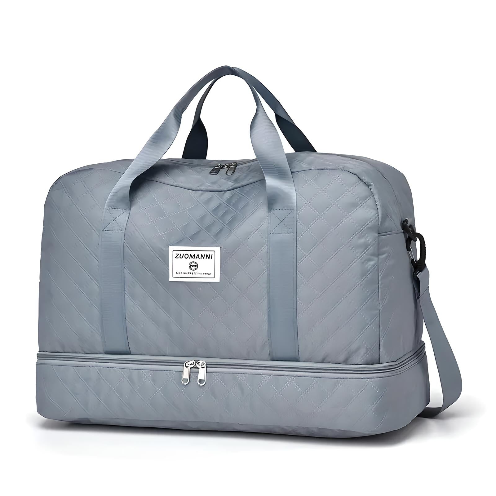 Gray quilted travel duffel bag with dual handles, detachable shoulder strap, and bottom compartment. Ideal for weekend trips and gym use.