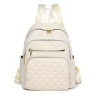 Elegant white leather backpack with quilted front pocket, gold zippers, and adjustable straps. Stylish women's fashion accessory for travel or daily use.