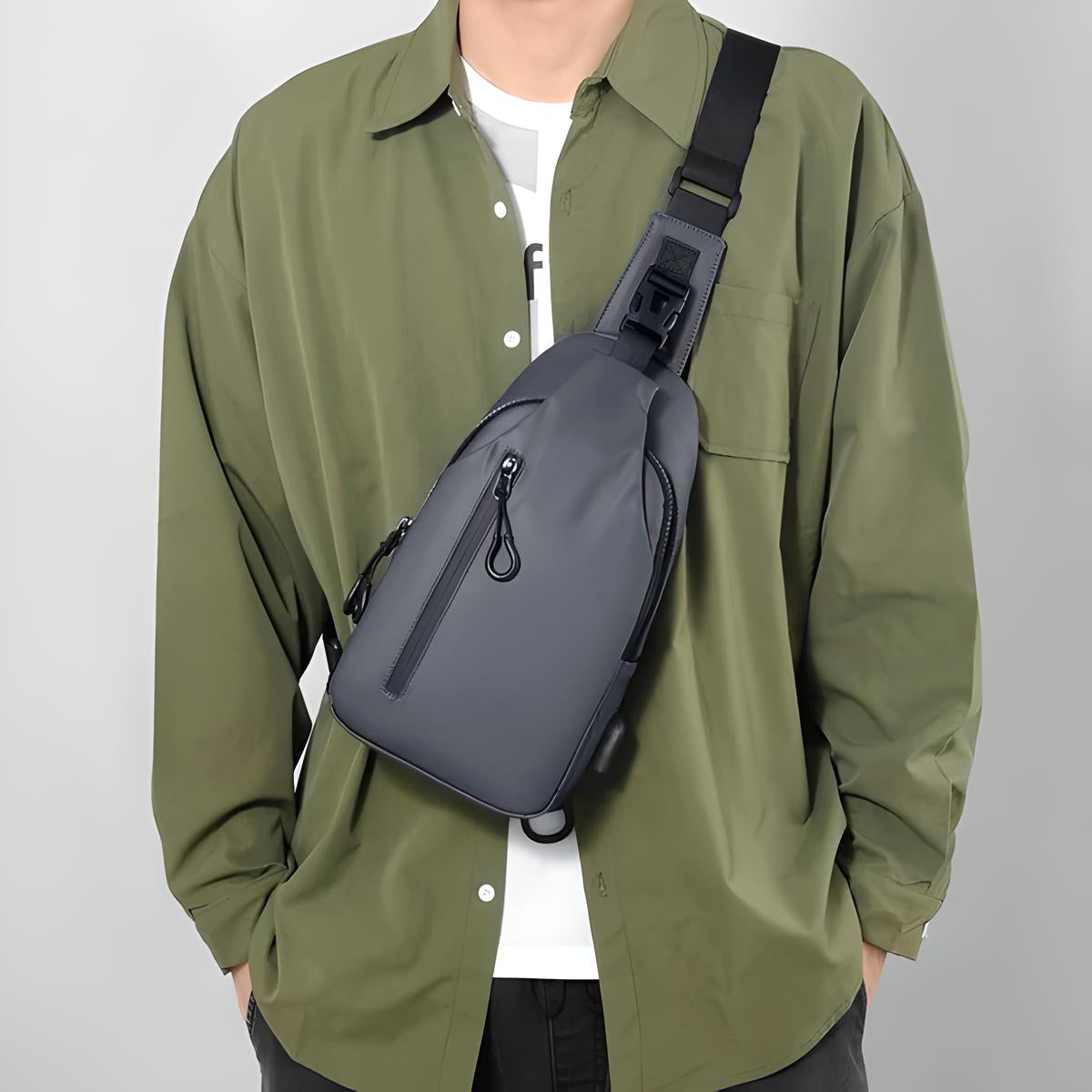 Man wearing a stylish olive green shirt with a sleek black crossbody sling bag, perfect for urban travel and fashion-forward everyday use.