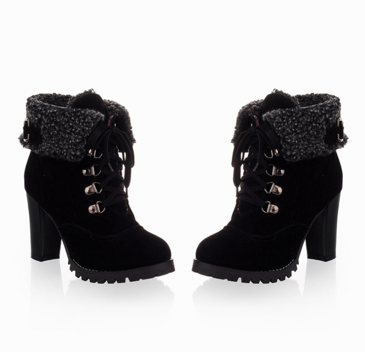 Black suede ankle boots with chunky high heels, lace-up front, and faux fur cuffs. Stylish women's winter footwear for fashion and comfort.