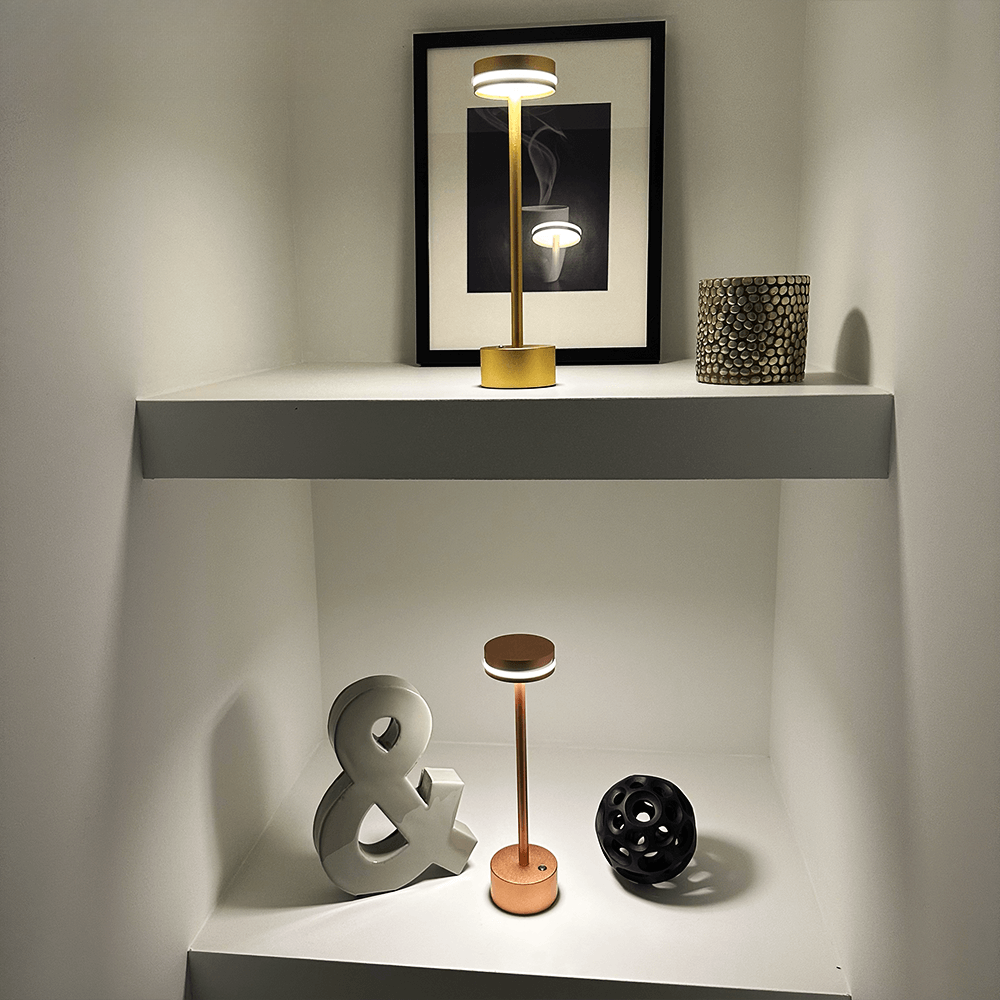 Modern minimalist shelf display featuring a sleek LED table lamp, decorative ampersand, and geometric art piece. Contemporary home decor accents.