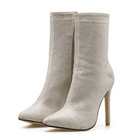 Elegant beige mesh ankle boots with stiletto heels, featuring a side zipper. Perfect for fashion-forward outfits and stylish evening wear.