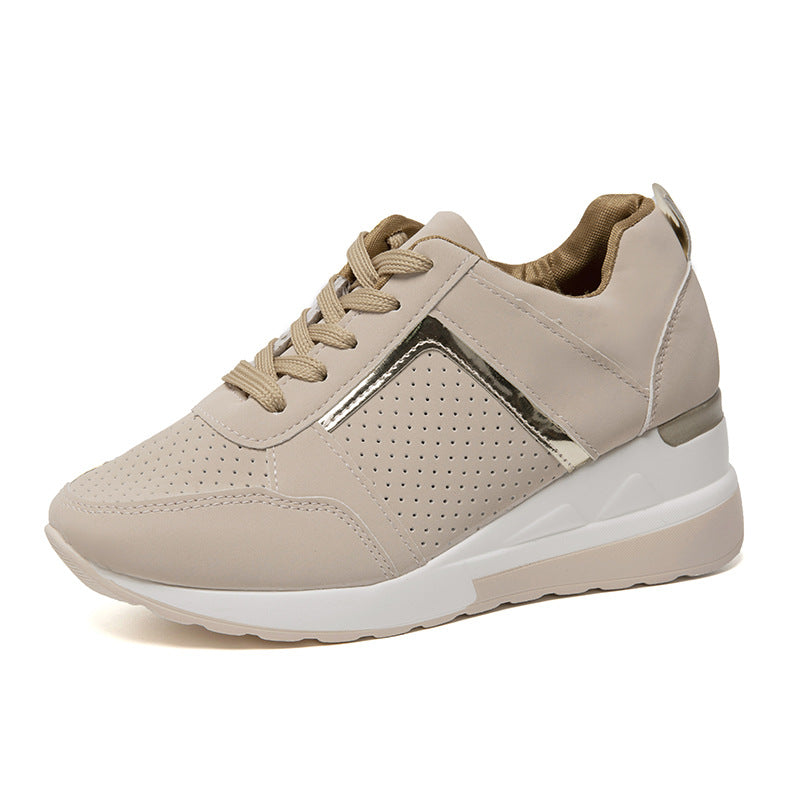 Beige women's sneaker with perforated design, metallic accents, and white sole. Stylish casual footwear, perfect for everyday comfort and fashion.