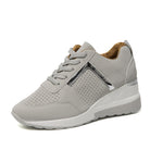 Gray women's athletic sneaker with perforated design, metallic accents, and white sole. Stylish, comfortable footwear for casual and sportswear.