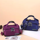 Two stylish travel duffel bags in purple and blue with multiple zippers and handles, perfect for weekend getaways and gym use.