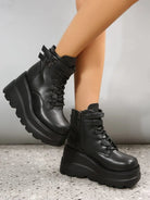 Black platform combat boots with chunky soles and lace-up design, featuring side zippers and ankle straps, perfect for edgy fashion and street style.