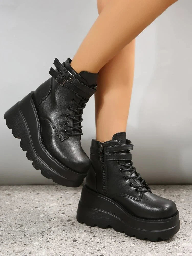 Black platform combat boots with chunky soles and lace-up design, featuring side zippers and ankle straps, perfect for edgy fashion and street style.