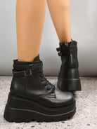 Black platform ankle boots with chunky soles and buckle straps, perfect for edgy fashion. Women's footwear, stylish and trendy design.