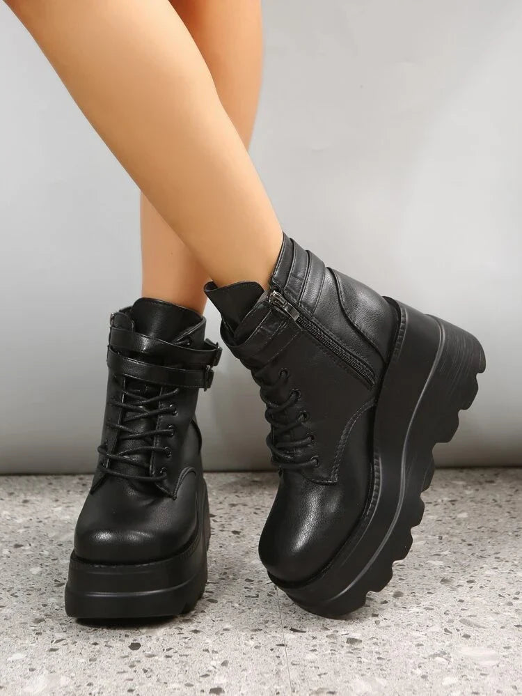 Black platform ankle boots with chunky soles, lace-up front, and side zipper. Trendy women's footwear for fall fashion. Stylish and comfortable design.