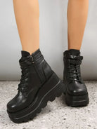 Black platform ankle boots with chunky soles and lace-up design, featuring side zippers. Trendy women's footwear for fashion-forward style.