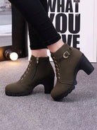 Olive green ankle boots with chunky heels, side zipper, and buckle detail, worn with black jeans. Stylish women's footwear for fall fashion.