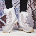 White and gray women's winter snow boots with fur lining, durable soles, and red laces, perfect for cold weather and outdoor activities.