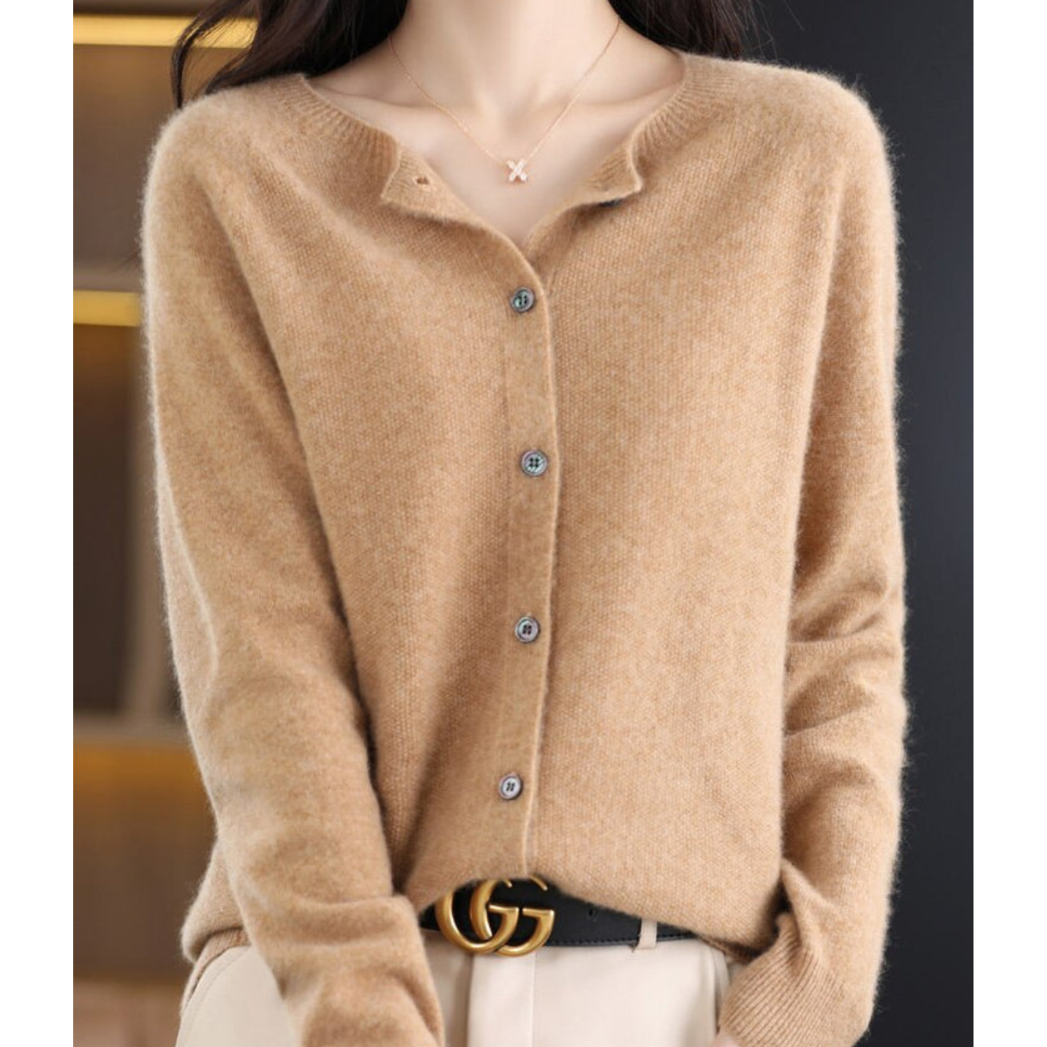 Beige cashmere cardigan with button front, worn by woman; stylish fall fashion outfit.