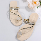 Elegant beige sandals with rhinestone embellishments and gold straps, perfect for summer fashion. Stylish women's footwear for casual and formal occasions.