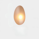 Modern oval wall sconce with warm LED light, minimalist design, perfect for contemporary home decor and ambient lighting solutions.