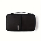 Black travel toiletry bag with handle, featuring a sleek design and durable material, ideal for organizing personal care items on trips.