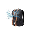 Waterproof black backpack with brown leather straps, splash-resistant design, ideal for travel and outdoor activities. Durable and stylish.