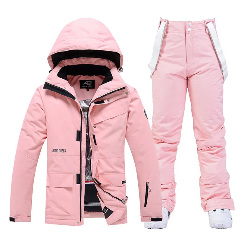 Pink women's ski jacket and pants set, waterproof, insulated, winter sportswear.