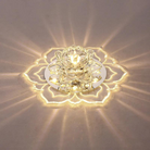 Crystal lotus LED ceiling light fixture with intricate petal design, emitting warm ambient glow. Perfect for modern home decor and lighting solutions.