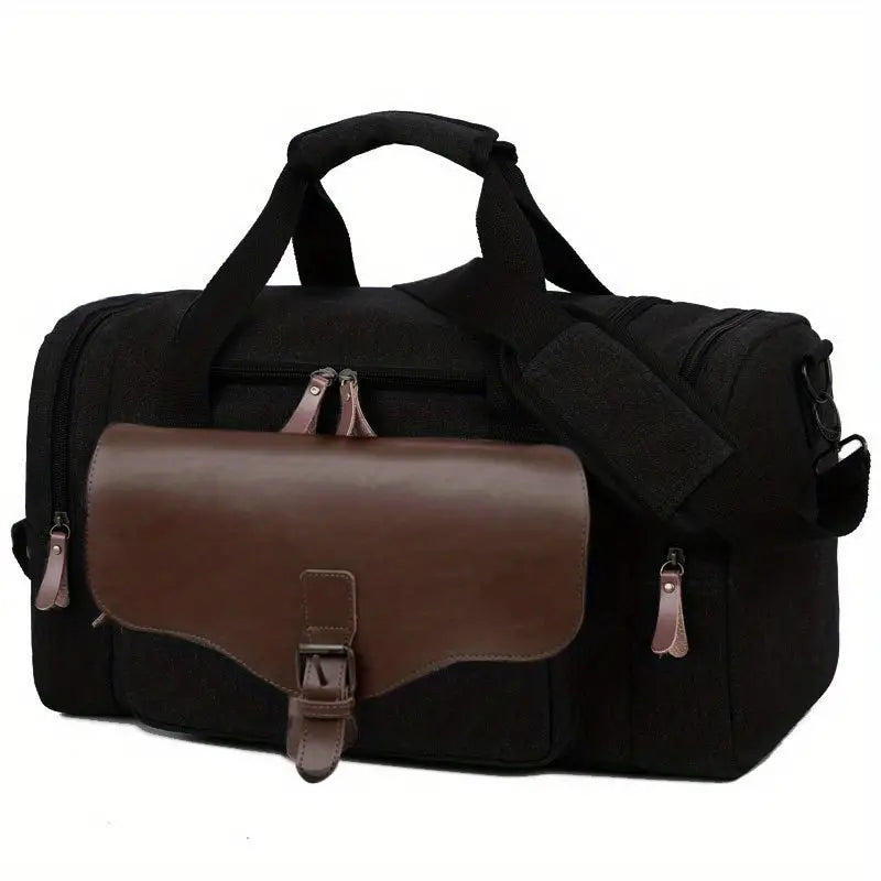 Black canvas duffel bag with brown leather flap pocket, adjustable shoulder strap, and multiple zippers. Ideal for travel, gym, or weekend trips.