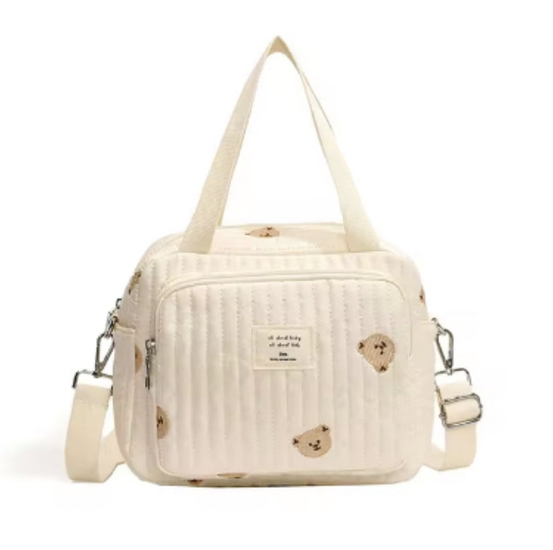 Cute quilted teddy bear print handbag with adjustable strap, cream color, perfect for casual outings. Trendy women's fashion accessory.