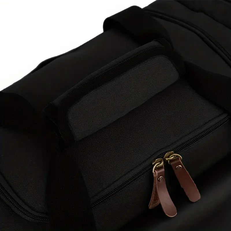 Black canvas duffel bag with leather zipper pulls, durable handles, and spacious design. Ideal for travel, gym, or weekend trips.