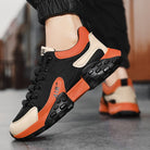 Stylish black and orange athletic sneakers with cushioned soles, breathable mesh, and durable design, perfect for running and casual wear.