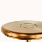 Sleek modern brass table lamp with circular design, minimalist style, and polished finish. Ideal for contemporary home decor and ambient lighting.