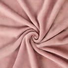 Soft pink fleece fabric texture, swirled pattern. Cozy, plush material ideal for blankets, upholstery, crafts. High-quality textile close-up.