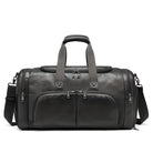 Sleek black leather duffel bag with multiple zippered compartments, adjustable shoulder strap, and sturdy handles. Ideal for travel and gym use.