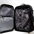 Open black travel backpack with spacious interior, featuring mesh pockets and compression straps, ideal for organized packing and efficient storage.