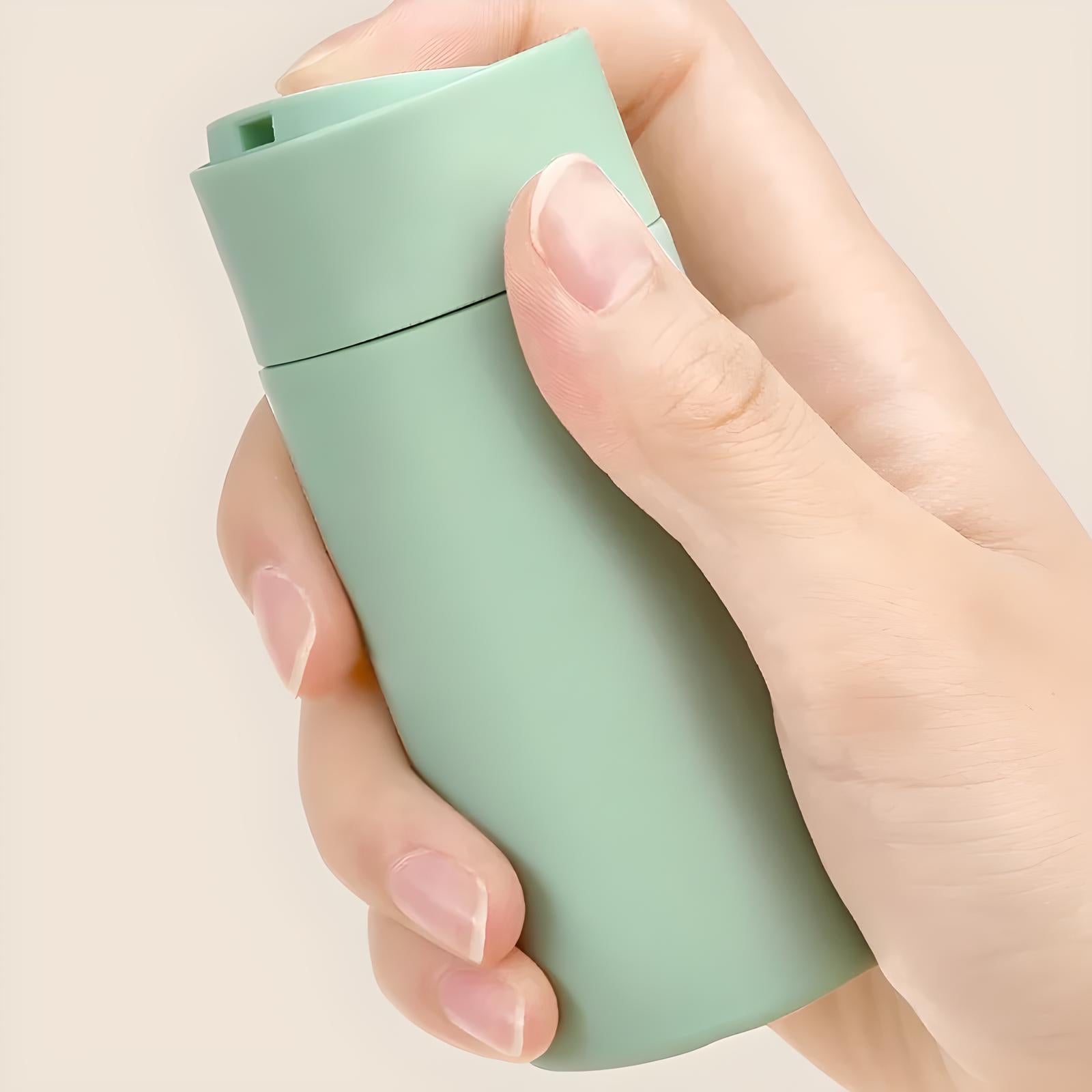 Hand holding a sleek, mint green reusable travel mug against a neutral background. Eco-friendly, portable coffee cup, sustainable lifestyle accessory.