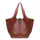 Brown leather tote bag with wide handles, spacious design, and sleek finish. Perfect for fashion, accessories, and women's handbags.