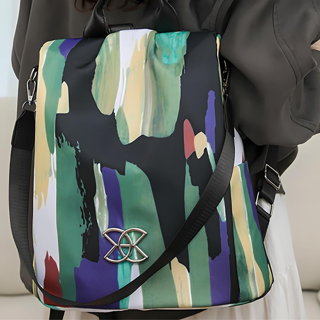 Stylish abstract print backpack with multicolor design, featuring a unique metal logo. Perfect for fashion-forward individuals seeking trendy accessories.