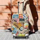 Colorful suitcase with vintage travel stickers, featuring movie tickets and travel labels, against a tiled wall. Perfect for travel enthusiasts.