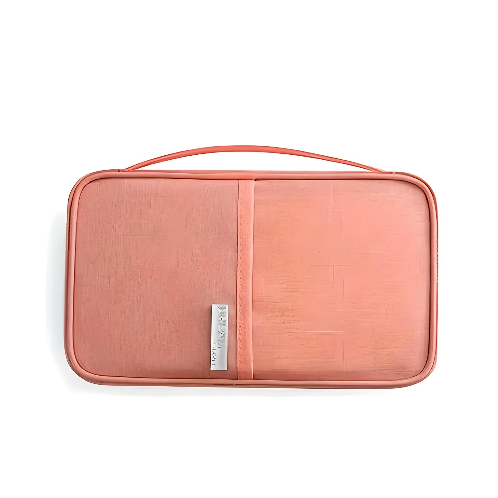 Coral pink travel toiletry bag with handle, sleek design, and branded metal tag. Ideal for organizing cosmetics and toiletries on the go.