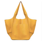 Yellow leather tote bag with wide handles, spacious design, and minimalist style. Perfect for fashion, accessories, and women's handbags keywords.