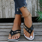 Women's black flip-flops with non-slip thick soles, gold chain detail, and casual summer style, perfect for beachwear and outdoor activities.