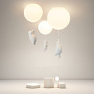 Modern ceiling light fixture with three glowing spherical lamps and playful bear sculptures, ideal for contemporary home decor and ambient lighting.