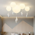 Modern ceiling light fixture with round globes and hanging polar bear designs, ideal for contemporary home decor and stylish interior lighting.