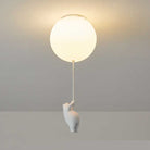 Modern ceiling light fixture with a round globe design and a playful bear figure hanging from a cord. Ideal for contemporary home decor lighting.