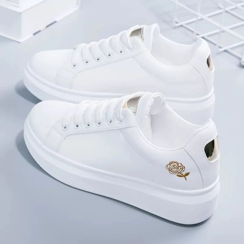 White women's casual sneakers with embroidered floral design, lace-up closure, breathable material. Perfect for spring and fall fashion trends.