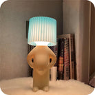 Unique humanoid table lamp with pleated blue lampshade, modern home decor, ambient lighting, cozy bedroom accessory, stylish nightstand light.