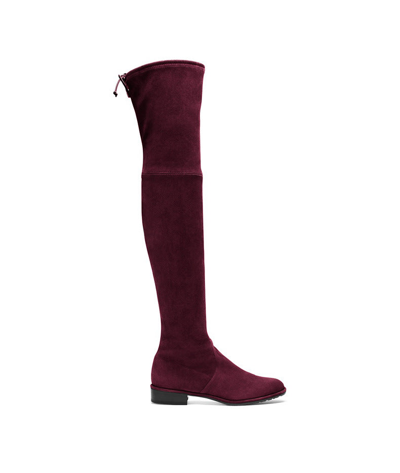 Burgundy over-the-knee suede boot with flat heel, side zipper, and sleek design. Perfect for stylish fall and winter fashion. Women's footwear.