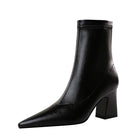 Sleek black leather ankle boot with pointed toe and block heel, perfect for women's fashion. Stylish footwear for fall and winter outfits.