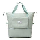 Mint green insulated cooler bag with dual handles, front pocket, and zipper closure. Ideal for picnics, travel, and outdoor activities.