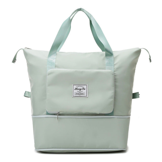 Mint green insulated cooler bag with dual handles, front pocket, and zipper closure. Ideal for picnics, travel, and outdoor activities.