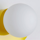 Modern white spherical wall lamp with yellow base, minimalist design, home decor lighting fixture, contemporary interior, energy-efficient LED.