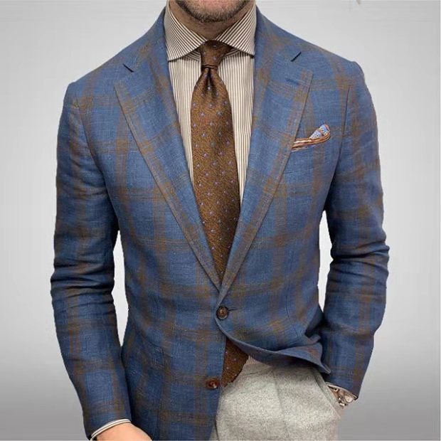 Men's blue plaid blazer with brown tie and striped shirt, elegant formal wear.